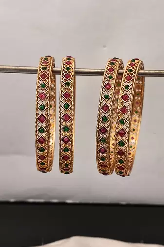 gold plated alloy bangles set with ruby green stones