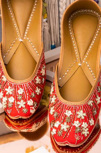 Red embroidered leather juttis