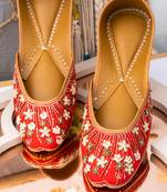 Red embroidered leather juttis