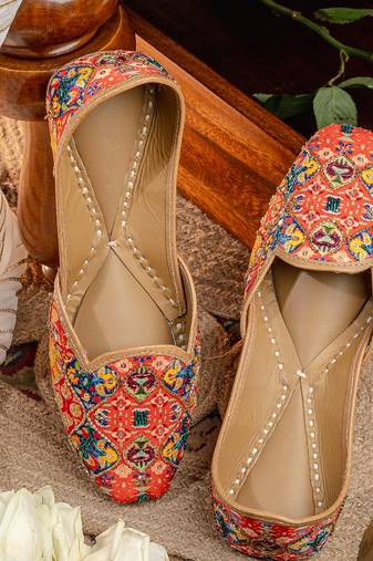 Red embroidered leather juttis