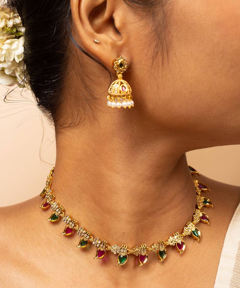 Gold-tone necklace with green & white stone accents & matching stud earrings