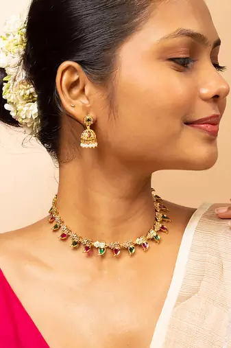 Gold-tone necklace with green & white stone accents & matching stud earrings
