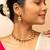 Gold-tone necklace with green & white stone accents & matching stud earrings