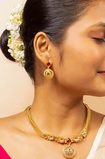 Gold chain necklace with traditional pendant and matching earrings