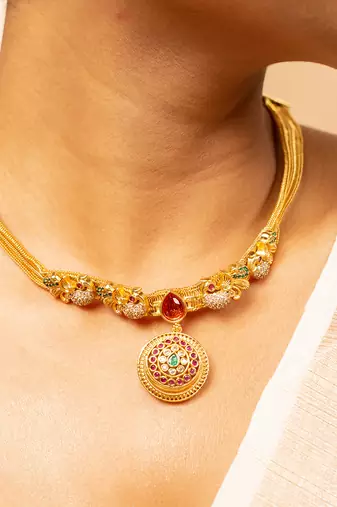 Gold chain necklace with traditional pendant and matching earrings