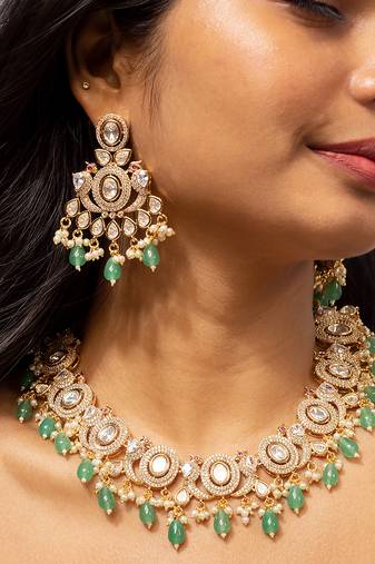 Elegant gold-toned kundan necklace set with green bead accents