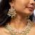 Elegant gold-toned kundan necklace set with green bead accents