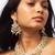 Elegant gold-toned kundan necklace set with green bead accents