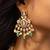 Elegant gold-toned kundan necklace set with green bead accents