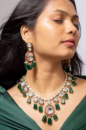 Royal gold-toned kundan necklace set with green beads and red detailing