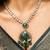 Elegant green stone pendant necklace set with kundan detailing