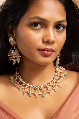 Stunning gold-toned kundan necklace set with pink and green bead drops
