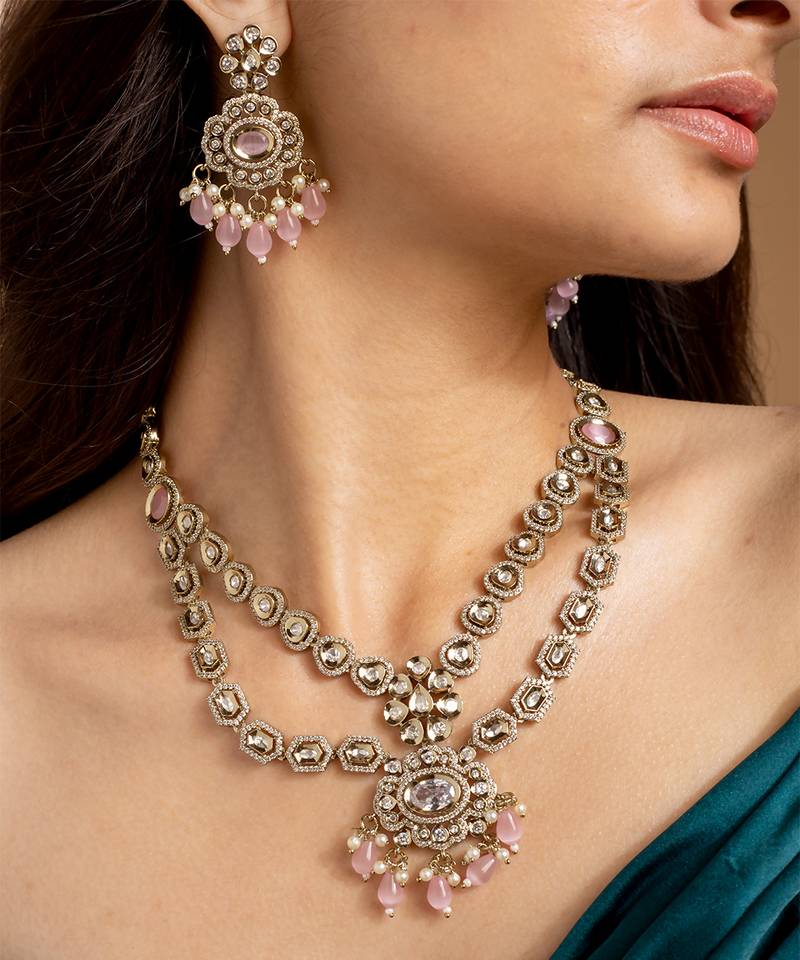 Elegant gold-toned necklace set with pink stones and pearls