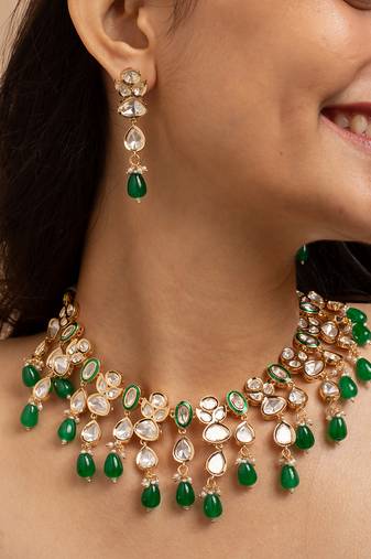 Traditional indian kundan necklace and earrings set with green bead accents