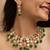 Traditional indian kundan necklace and earrings set with green bead accents