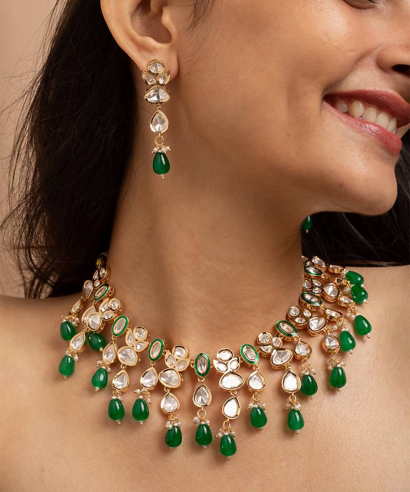 Traditional indian kundan necklace and earrings set with green bead accents