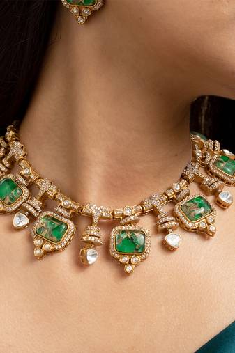 Indian necklace and earrings set with green and clear stone detailing