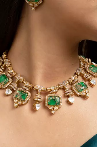 Indian necklace and earrings set with green and clear stone detailing