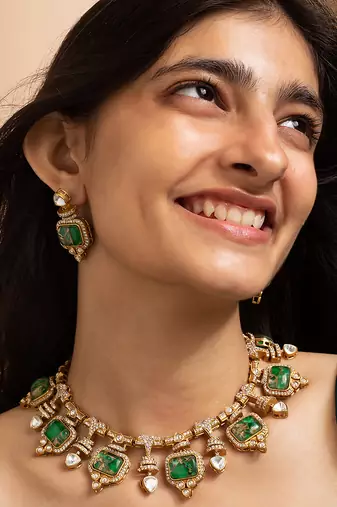 Indian necklace and earrings set with green and clear stone detailing