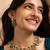 Indian necklace and earrings set with green and clear stone detailing