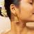 Traditional gold-plated jhumka earrings with pearl detailing