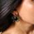 Black rodium geometric flower earrings with green gem