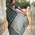 Green self design embellished silk blend saree with blouse