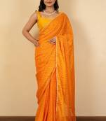 Women's bright orange chevron print golden lace border chiffon saree with unstiched blouse piece