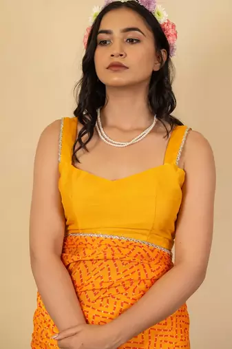 Women's bright orange chevron print golden lace border chiffon saree with unstiched blouse piece