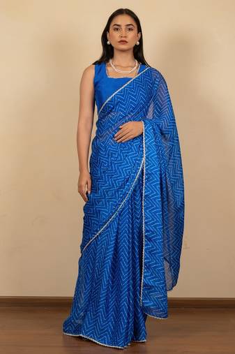 Women's royal blue chevron print golden lace border chiffon saree with unstiched blouse piece