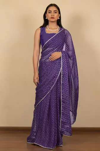 Women's purple chevron print golden lace border chiffon saree with unstiched blouse piece
