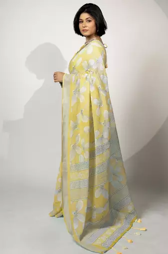 Women's pastel yellow floral print silver zari border cotton blend saree with unstiched blouse piece