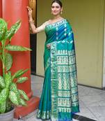 Green dual toned pure handwoven baluchari silk saree with exquisite resham work in copper color