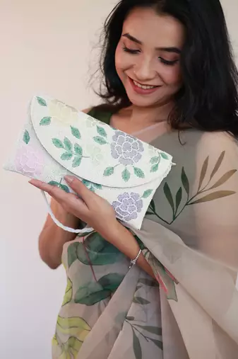 Osty lush – floral hand zari beaded clutch with dual handle | ivory base pastel embroidery bag- multy