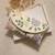 Osty lush – floral hand zari beaded clutch with dual handle | ivory base pastel embroidery bag- multy