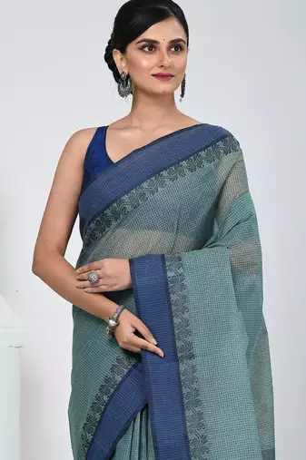 Elegant teal and navy blue striped tant saree with floral border