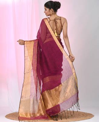 Elegant magenta and gold linen saree with striped borders 3