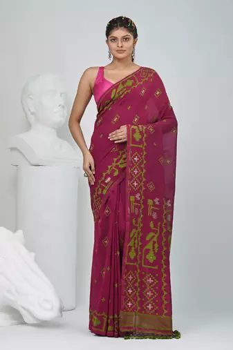 Magenta cotton saree with traditional woven patterns and tassel border