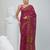 Magenta cotton saree with traditional woven patterns and tassel border