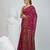 Magenta cotton saree with traditional woven patterns and tassel border