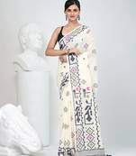 Off white cotton saree with traditional woven patterns and tassel border