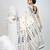 Off white cotton saree with traditional woven patterns and tassel border