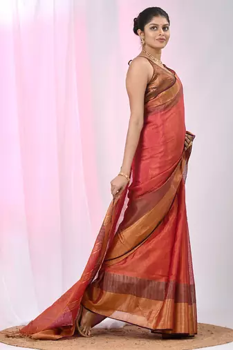 Elegant red tissue saree with contrasting golden border