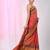 Elegant red tissue saree with contrasting golden border