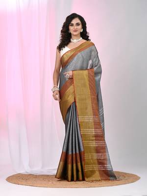Elegant grey tissue saree with contrasting golden border 1