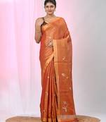 Orange tissue saree with ethnic motifs and golden border
