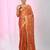 Orange tissue saree with ethnic motifs and golden border