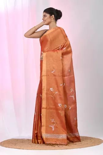 Orange tissue saree with ethnic motifs and golden border