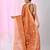 Orange tissue saree with ethnic motifs and golden border