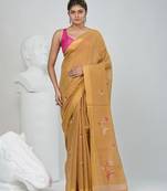 Beige tissue saree with ethnic motifs and golden border